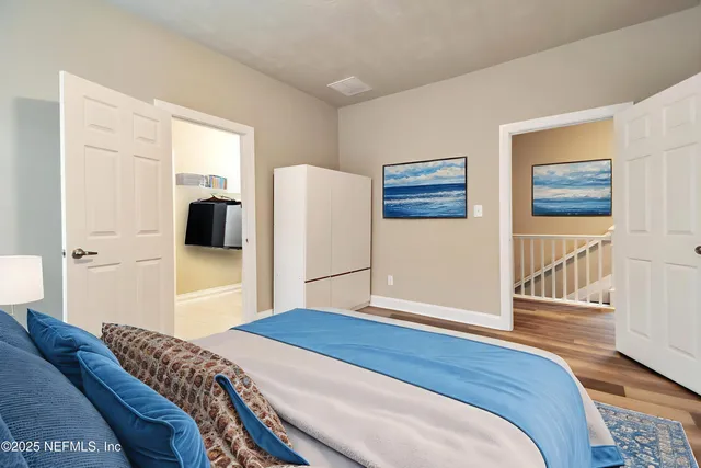 a bedroom with a bed and a refrigerator