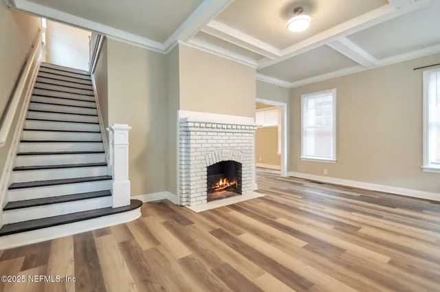 a view of a livingroom with a fireplace and window