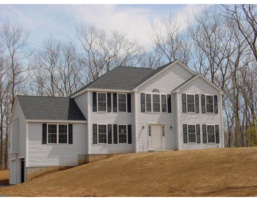 14-b-128 Clarke Farm Road Windham, NH 03087 - Photo 1 of 1 a front view of a house with a yard