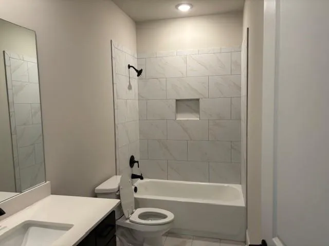 a bathroom with a toilet a sink and shower