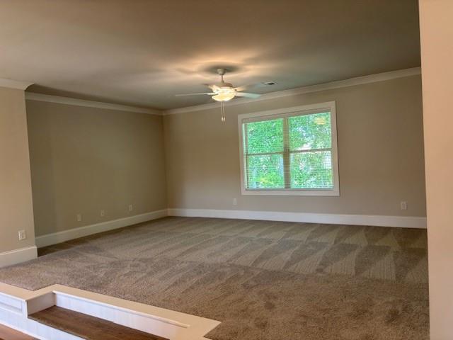 4015 Sierra Vista Circle Cumming, GA 30040 - Photo 15 of 29 an empty room with a chandelier fan and windows