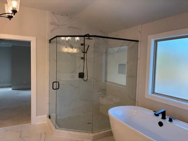 a bathroom with a bathtub and a shower