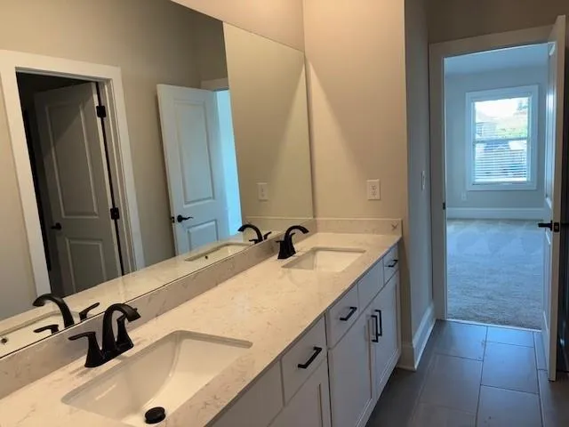 a bathroom with a tub sink and mirror