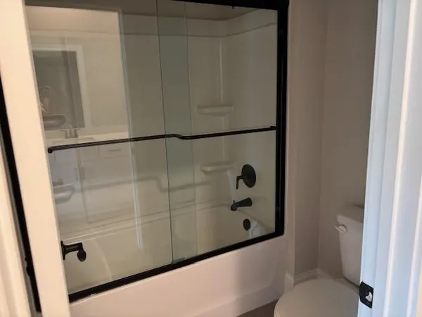 a bathroom with a shower and toilet