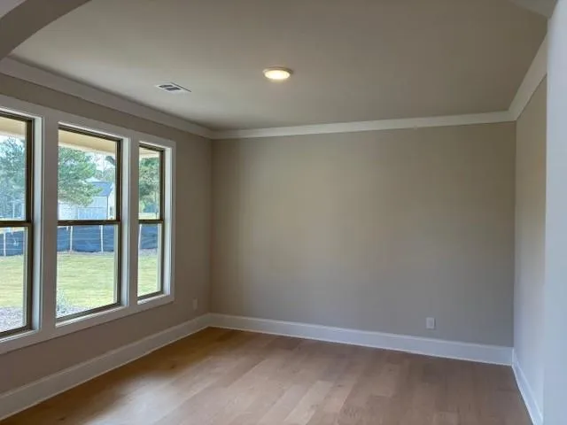 wooden floor in an empty room with a window