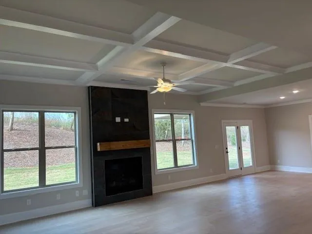 a view of an empty room with a fireplace and a window