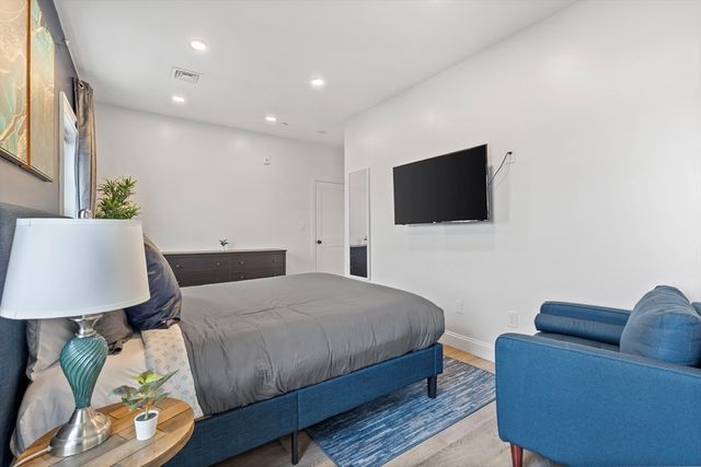 a bedroom with a bed and a flat screen tv