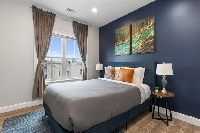 a bedroom with a bed and a window