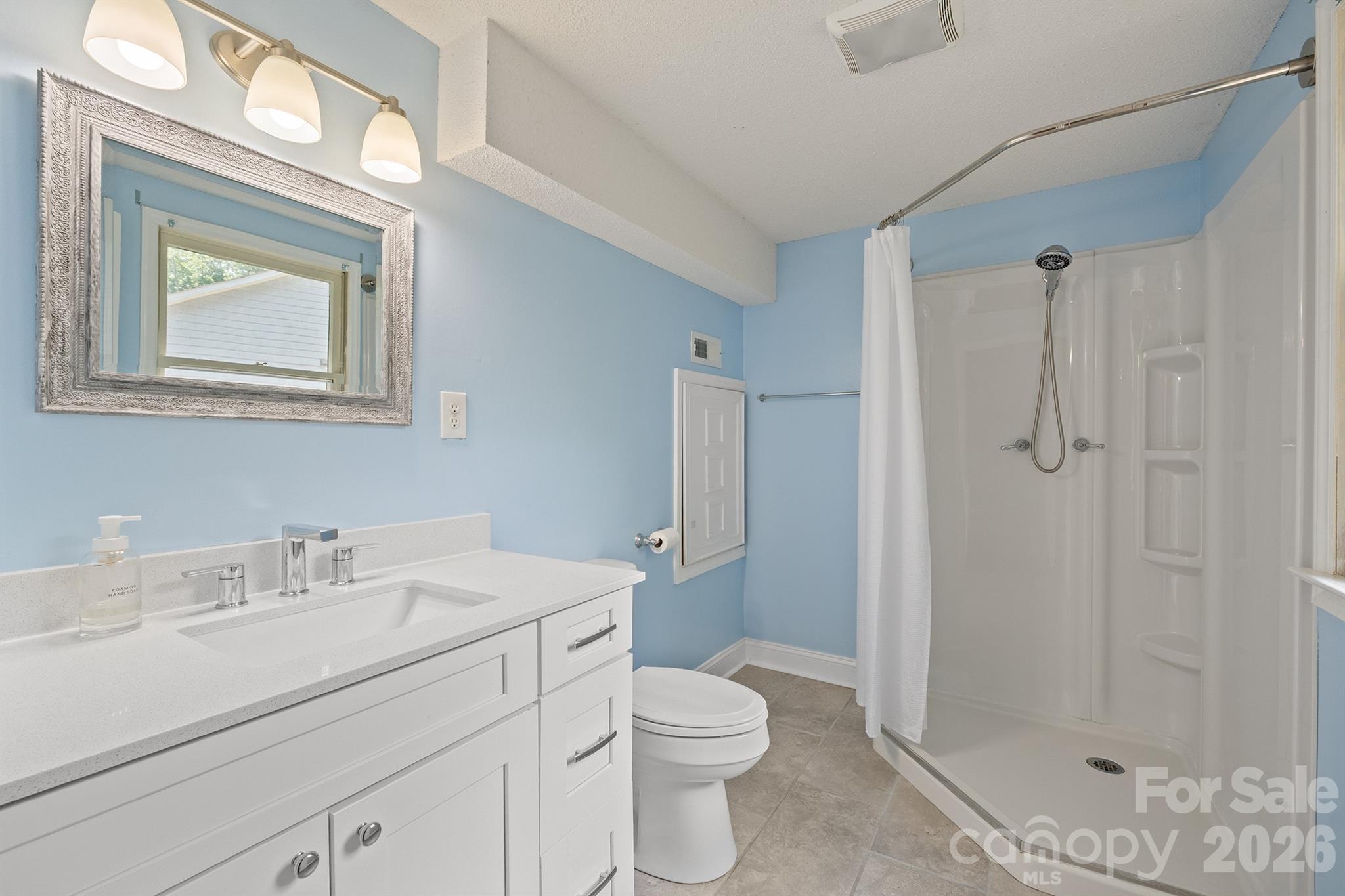 19017 Kailua Circle Tega Cay, SC 29708 - Photo 35 of 46 a bathroom with a toilet sink vanity and shower