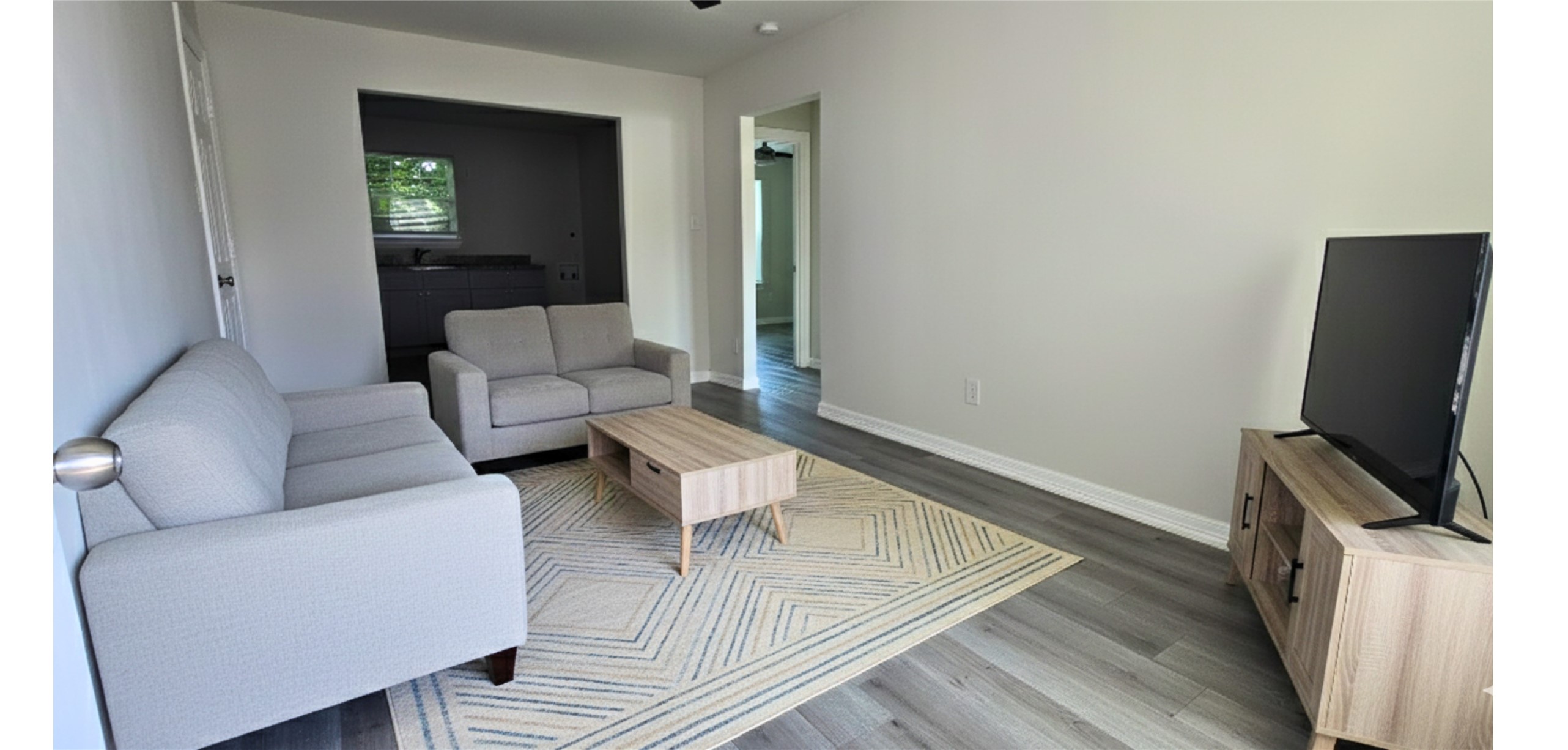 3610 Tuam Street Houston, TX 77004 - Photo 3 of 7 a living room with furniture and a flat screen tv
