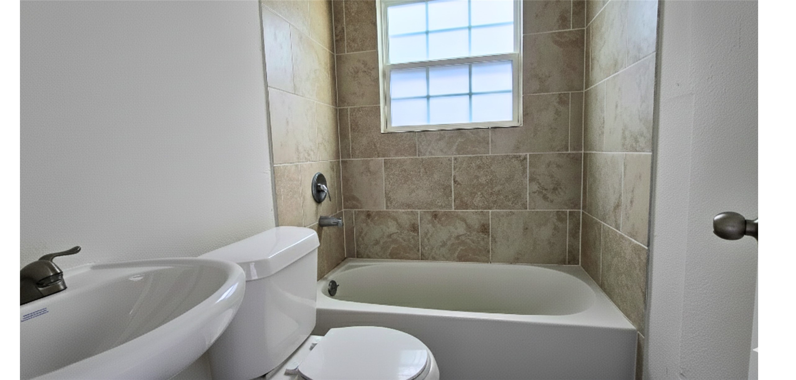 3610 Tuam Street Houston, TX 77004 - Photo 7 of 7 a white bath tub sitting next to a white toilet