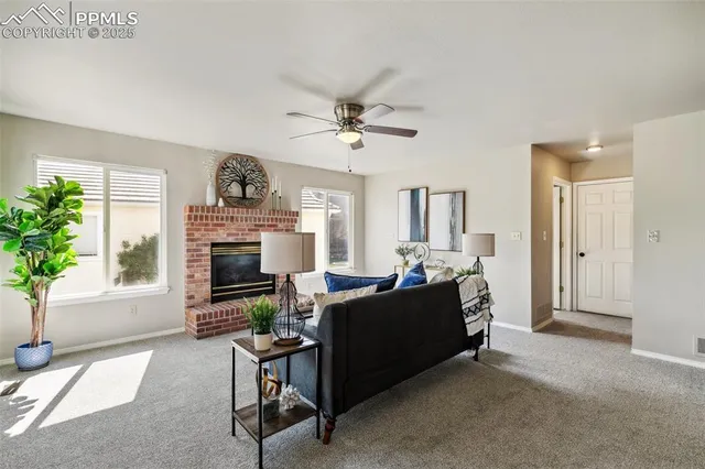 a living room with furniture and a fireplace