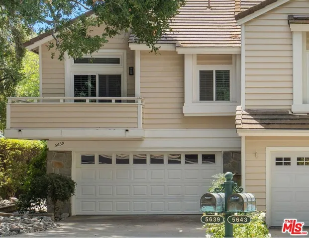 a front view of a house with a garage