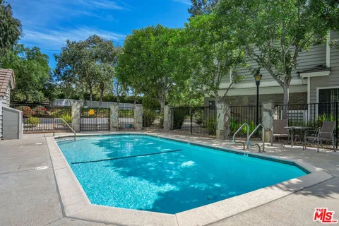 swimming pool view with sitting space and garden view