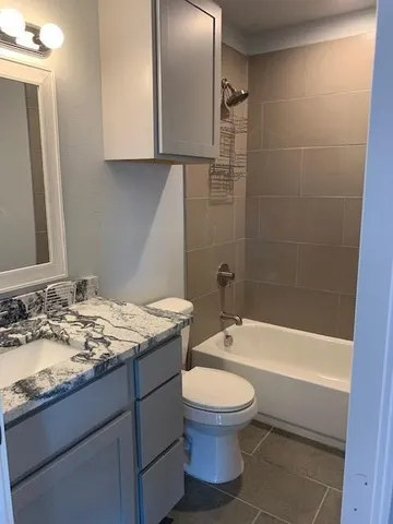 a bathroom with a sink a toilet and bathtub