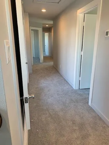 a view of a small space with wooden floor and a window