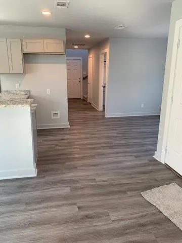 a view of hallway with wooden floor