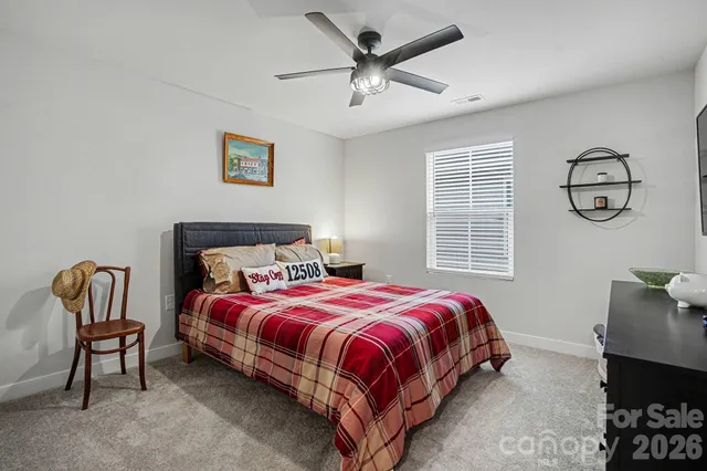 a bedroom with a bed and painting on the wall