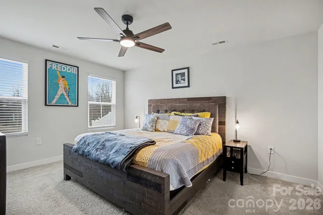 a bedroom with a bed and ceiling fan