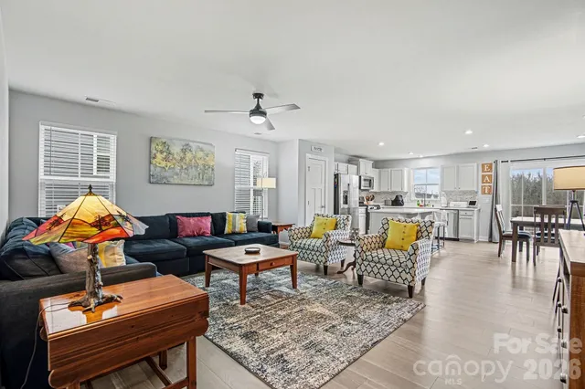 a living room with furniture kitchen view and a table