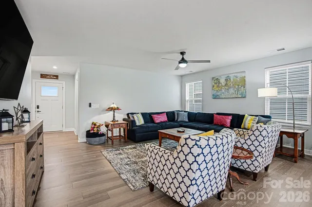 a open dining room with stainless steel appliances kitchen island granite countertop a dining table chairs and granite counter tops