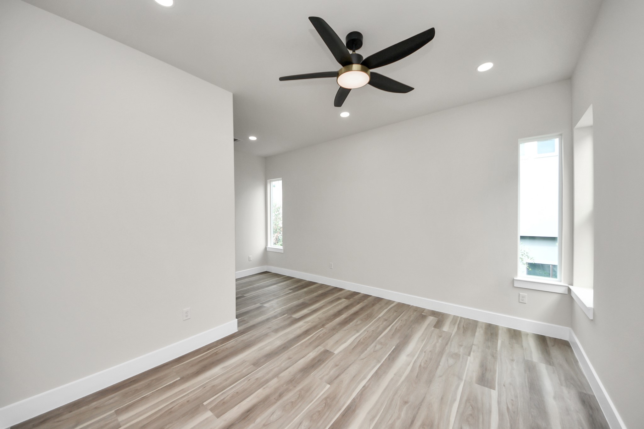 2014 Blodgett Street Houston, TX 77004 - Photo 38 of 49 an empty room with wooden floor and windows