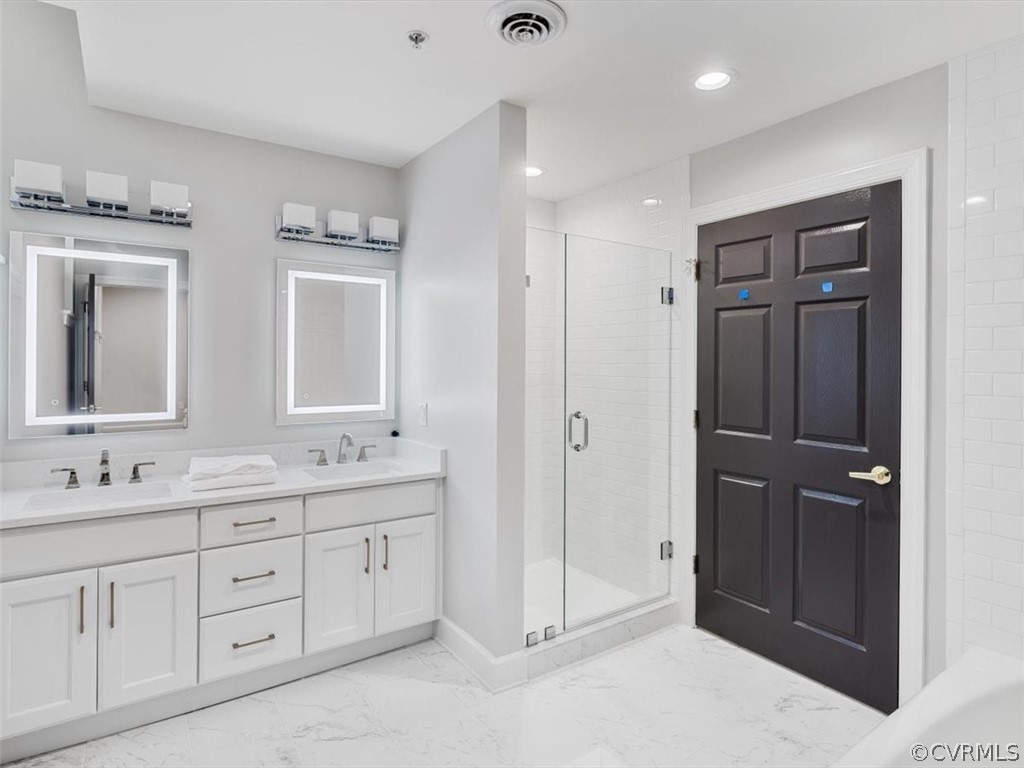 413 Stuart Circle, Unit UPLC Richmond, VA 23220 - Photo 15 of 36 a spacious bathroom with double vanity and a mirror