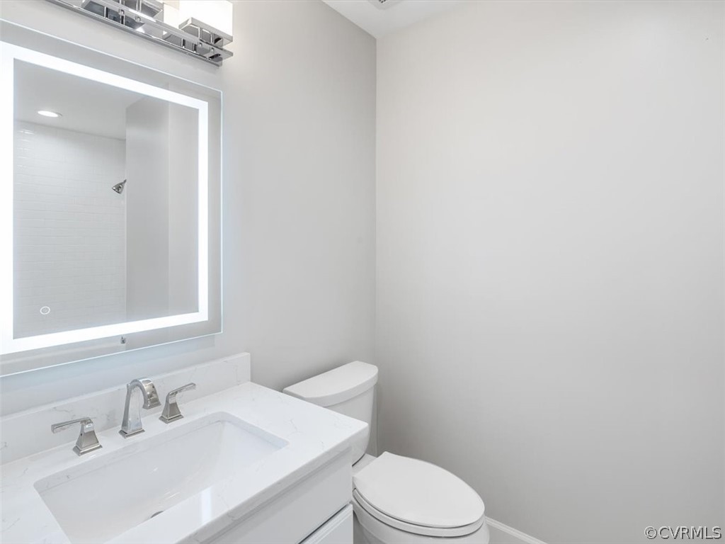 413 Stuart Circle, Unit UPLC Richmond, VA 23220 - Photo 20 of 36 a bathroom with a sink a toilet and mirror