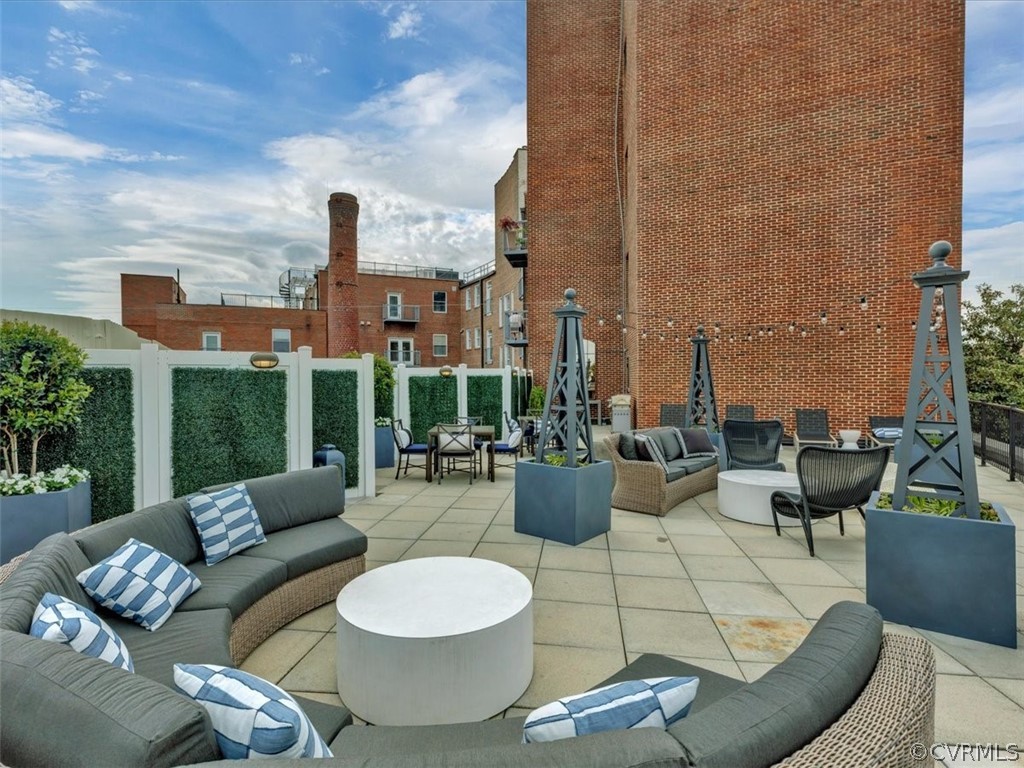 413 Stuart Circle, Unit UPLC Richmond, VA 23220 - Photo 26 of 36 a view of a patio with couches and potted plants