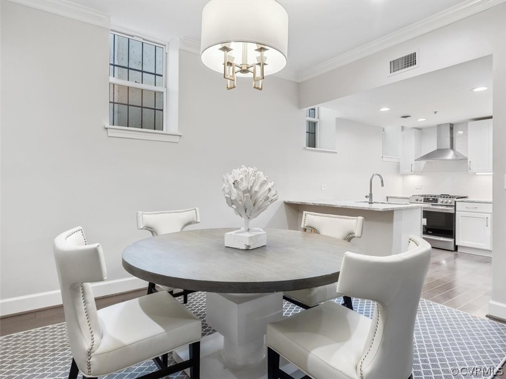 413 Stuart Circle, Unit UPLC Richmond, VA 23220 - Photo 8 of 36 a view of a dining room with furniture and chandelier