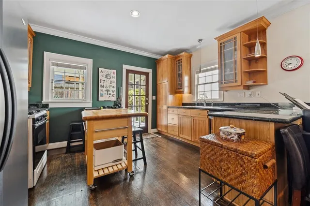 a kitchen with stainless steel appliances granite countertop a stove a sink and a refrigerator