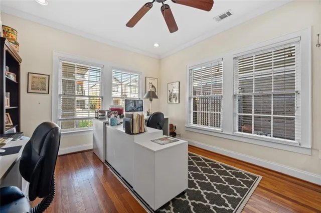 a dining room with wooden floor and furniture