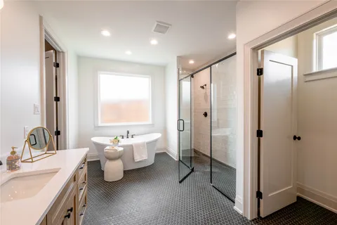 a bathroom with a double vanity sink mirror and toilet