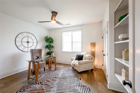 a living room with furniture a chandelier and a window