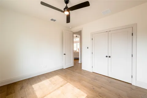 a view of a room with wooden floor closet and windows