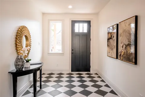 a view of a bedroom with a window and wooden floor