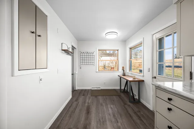 a view of a room with wooden floor and windows