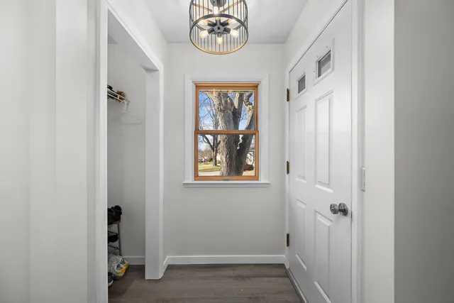 a view of an entryway with wooden floor