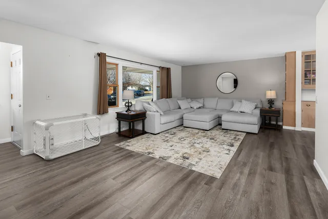 a living room with furniture and wooden floor