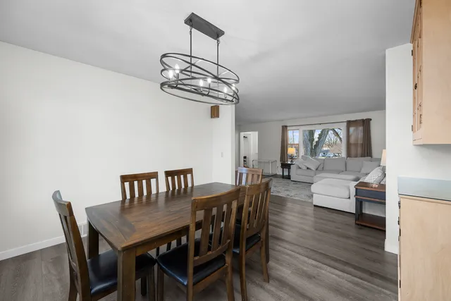 a view of a dining room with furniture wooden floor and chandelier
