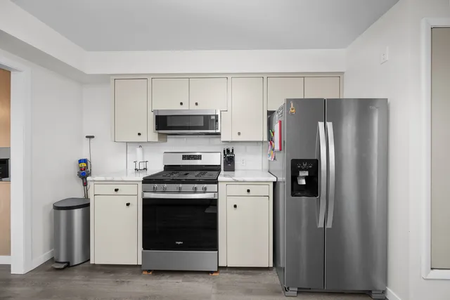 a kitchen with a stove cabinets and refrigerator