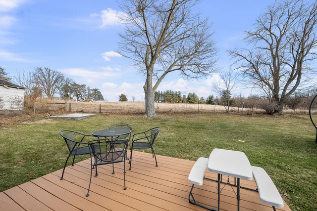 a view of a large house with a big yard and large tree