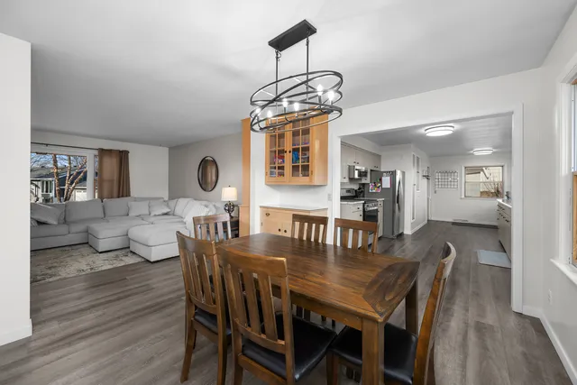a view of a dining room with furniture wooden floor and chandelier