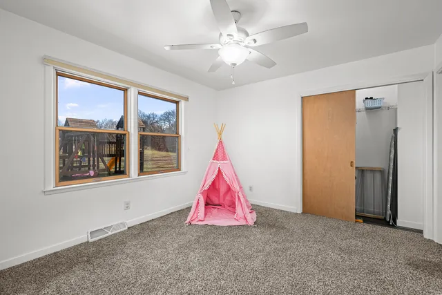 a room with window and ceiling fan
