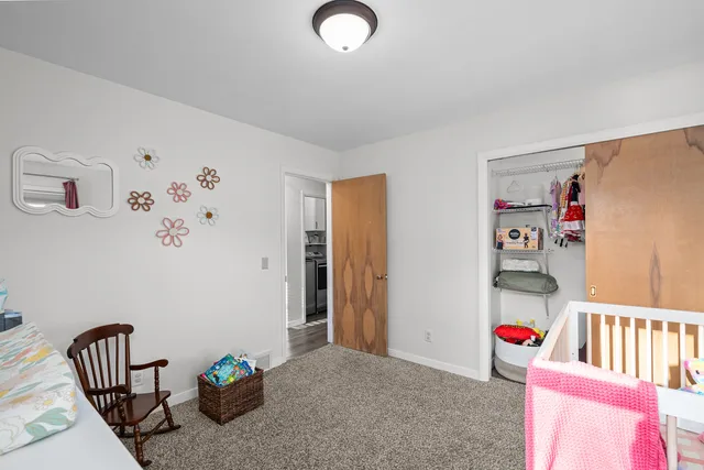 a bedroom with furniture a rug and a window