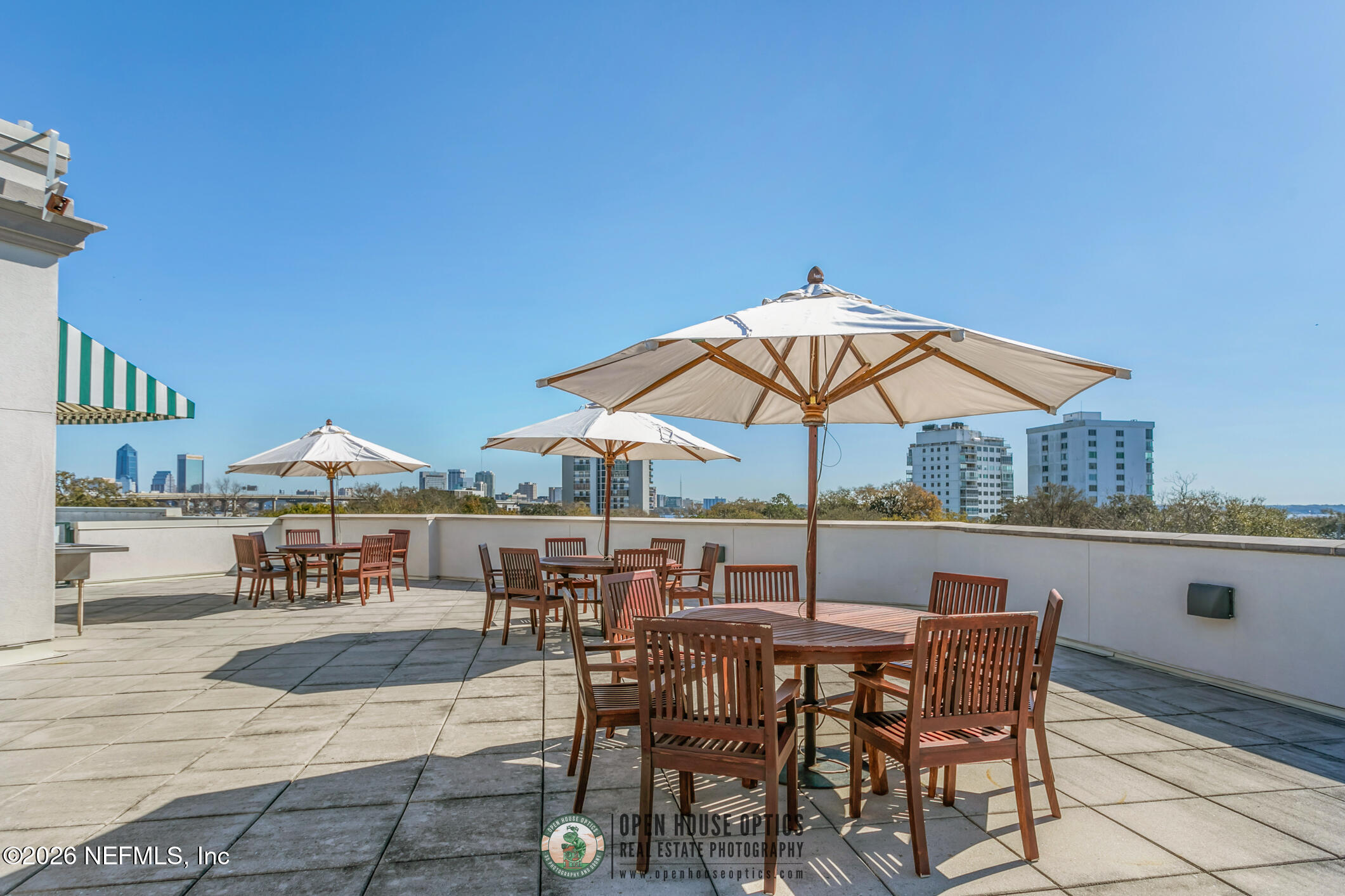 1661 Riverside Avenue, Unit 407 Jacksonville, FL 32204 - Photo 40 of 60 a view of furniture and table under an umbrella