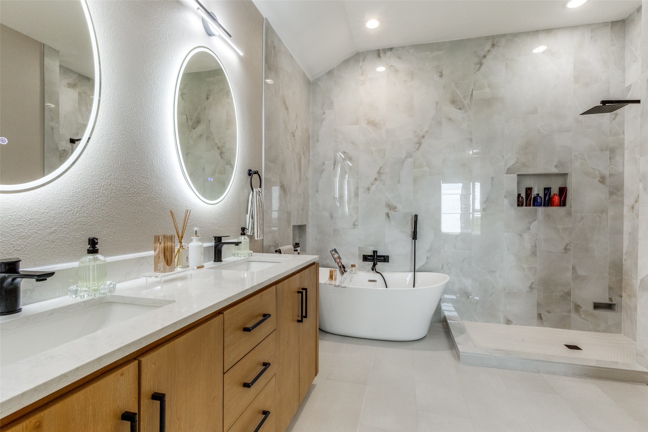 2312 Rivina Drive Austin, TX 78733 - Photo 23 of 40 Full bath with double vanity, walk in shower, a freestanding bath, recessed lighting, and tile walls