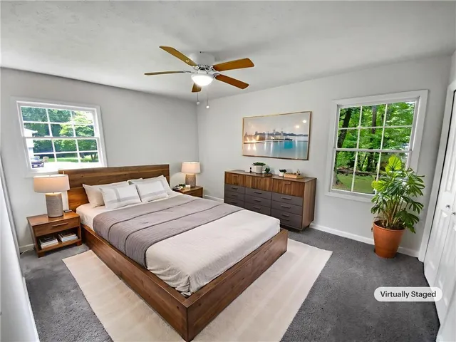 a bedroom with a large bed and a window