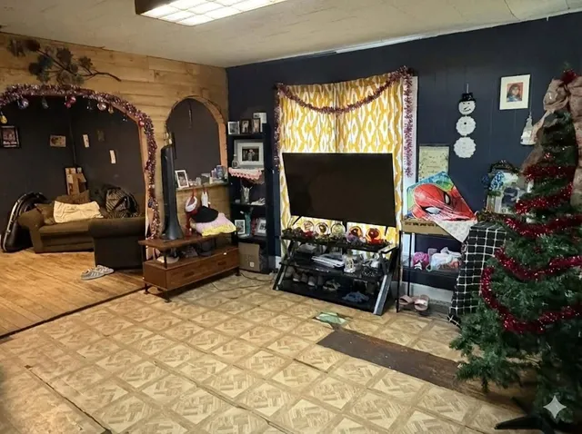 a living room with furniture a flat screen tv and a fireplace