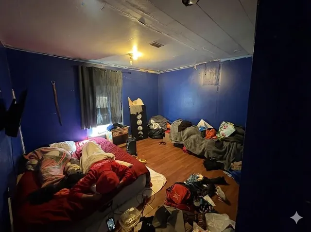 a bedroom with two beds and a lamp